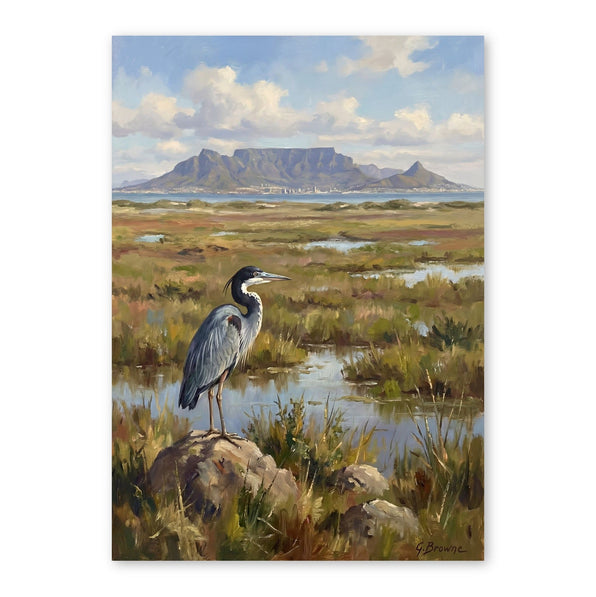 Great blue heron standing on rocks in a wetland with mountains and water in background